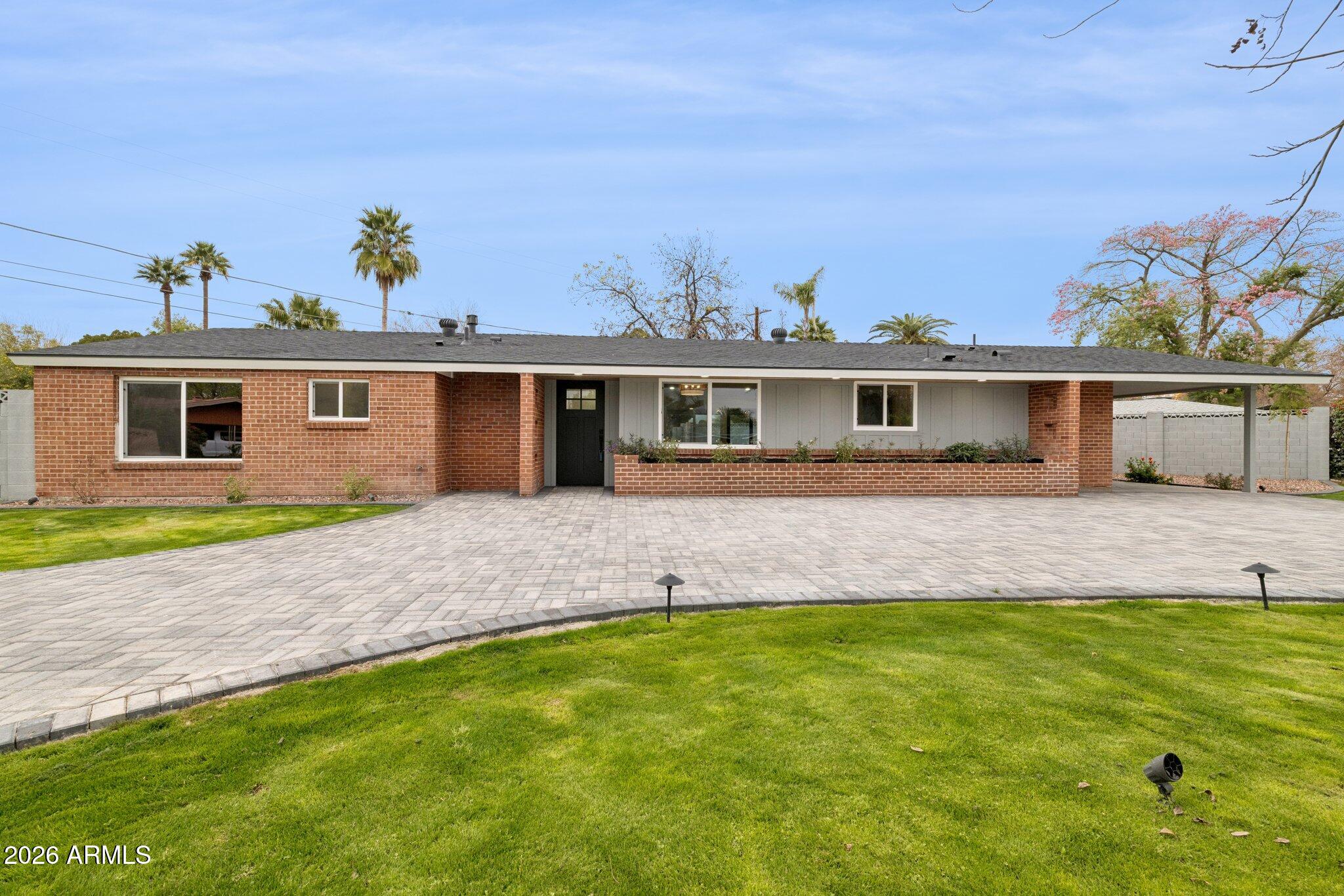 1216 West Rovey Avenue Phoenix, AZ 85013 - Photo 3 of 45 a front view of a house with a yard