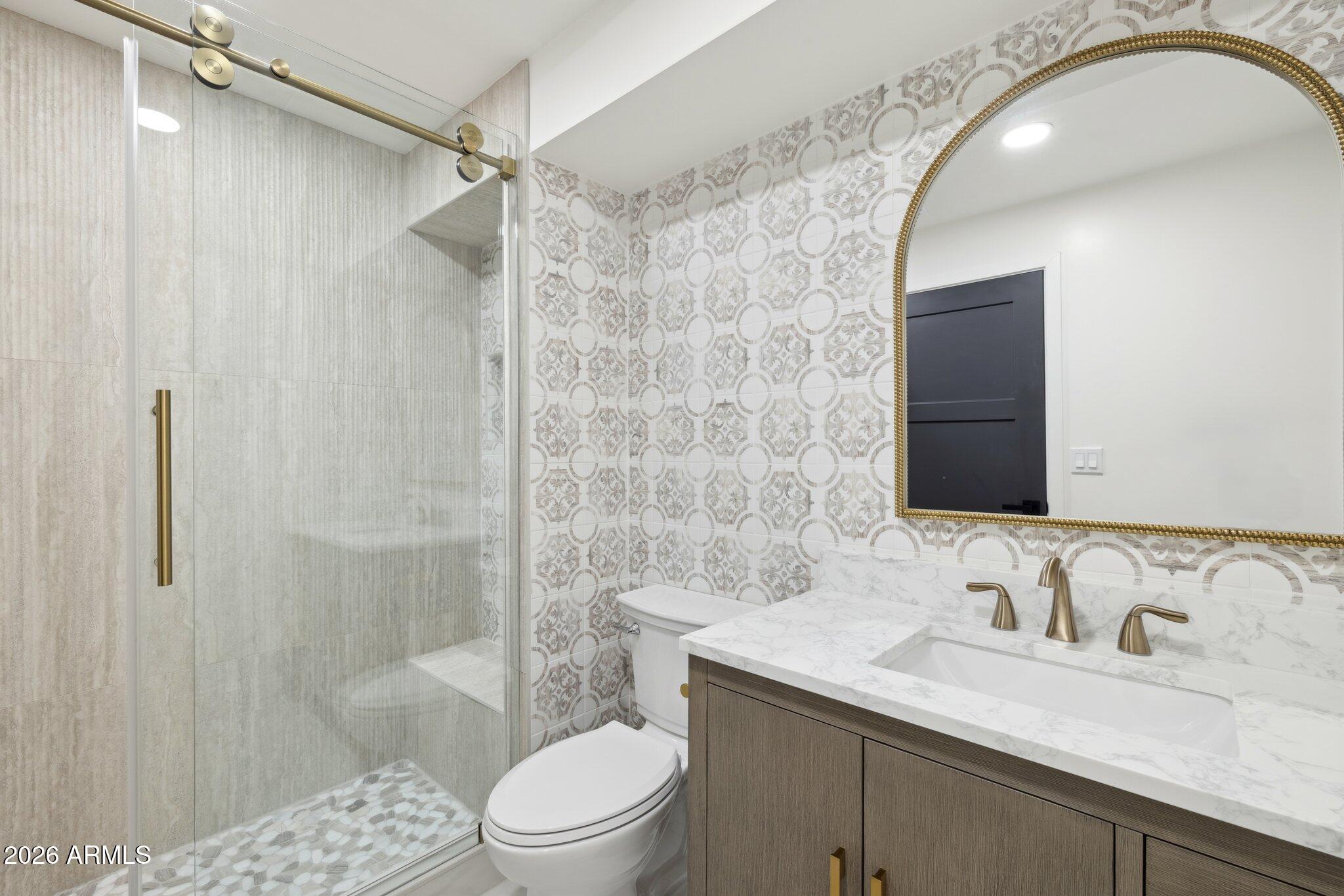 1216 West Rovey Avenue Phoenix, AZ 85013 - Photo 31 of 45 a bathroom with a sink a toilet and shower