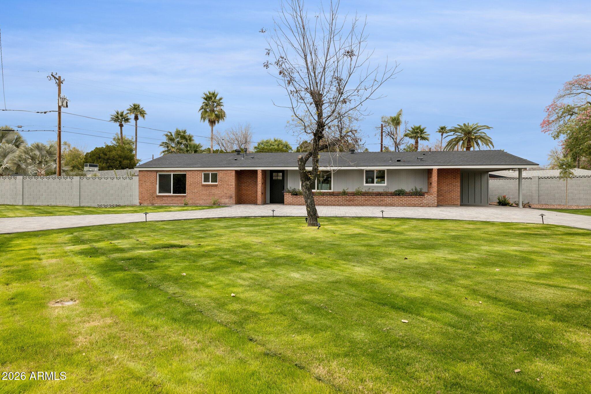 1216 West Rovey Avenue Phoenix, AZ 85013 - Photo 45 of 45 a front view of a house with a garden