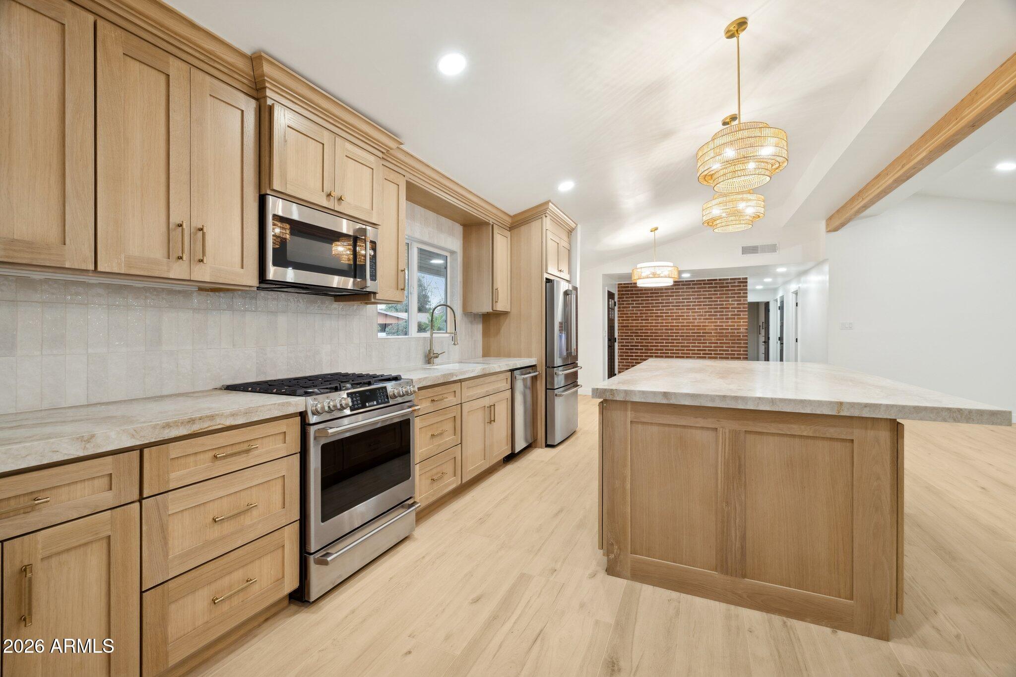 1216 West Rovey Avenue Phoenix, AZ 85013 - Photo 9 of 45 a kitchen with stainless steel appliances granite countertop a stove a sink and a microwave