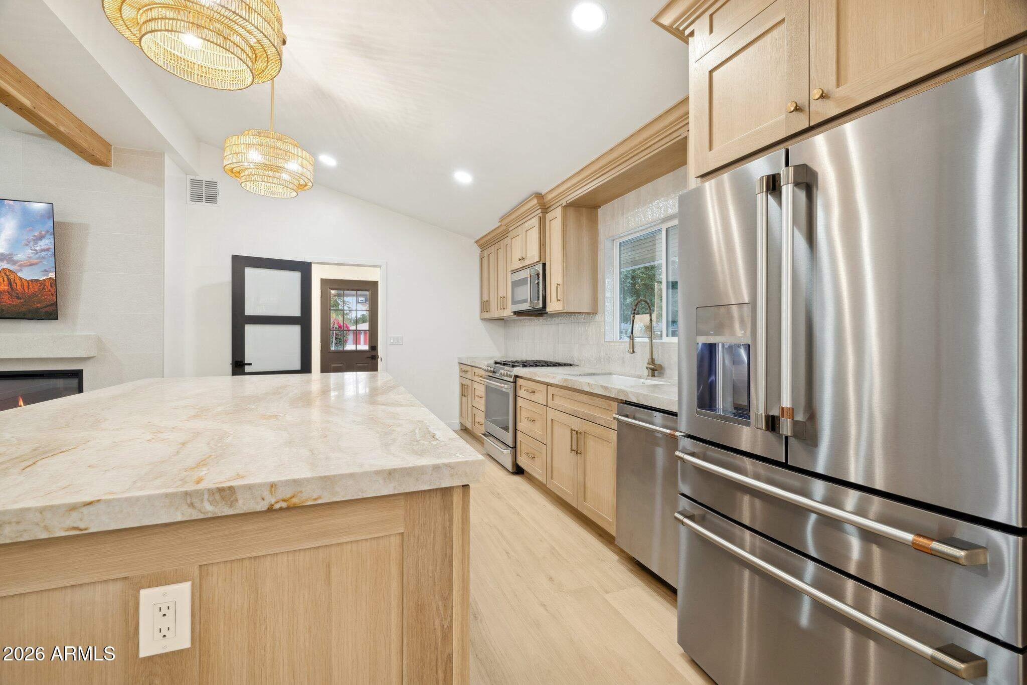 1216 West Rovey Avenue Phoenix, AZ 85013 - Photo 10 of 45 a kitchen with stainless steel appliances a refrigerator sink and stove