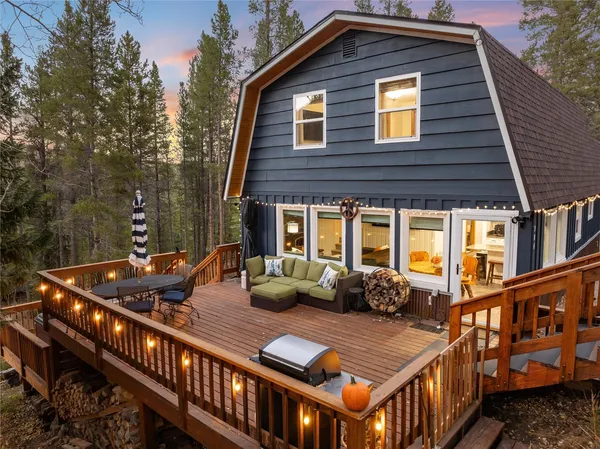 a front view of a house with balcony and outdoor seating