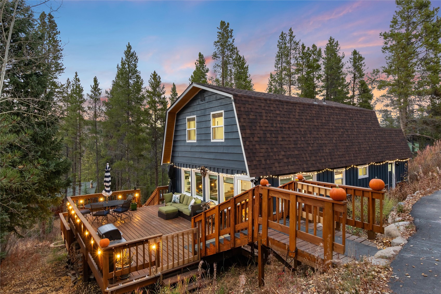 384 Blue Ridge Road Breckenridge, CO 80424 - Photo 16 of 39 a view of a roof deck with table and chairs with wooden floor and fence
