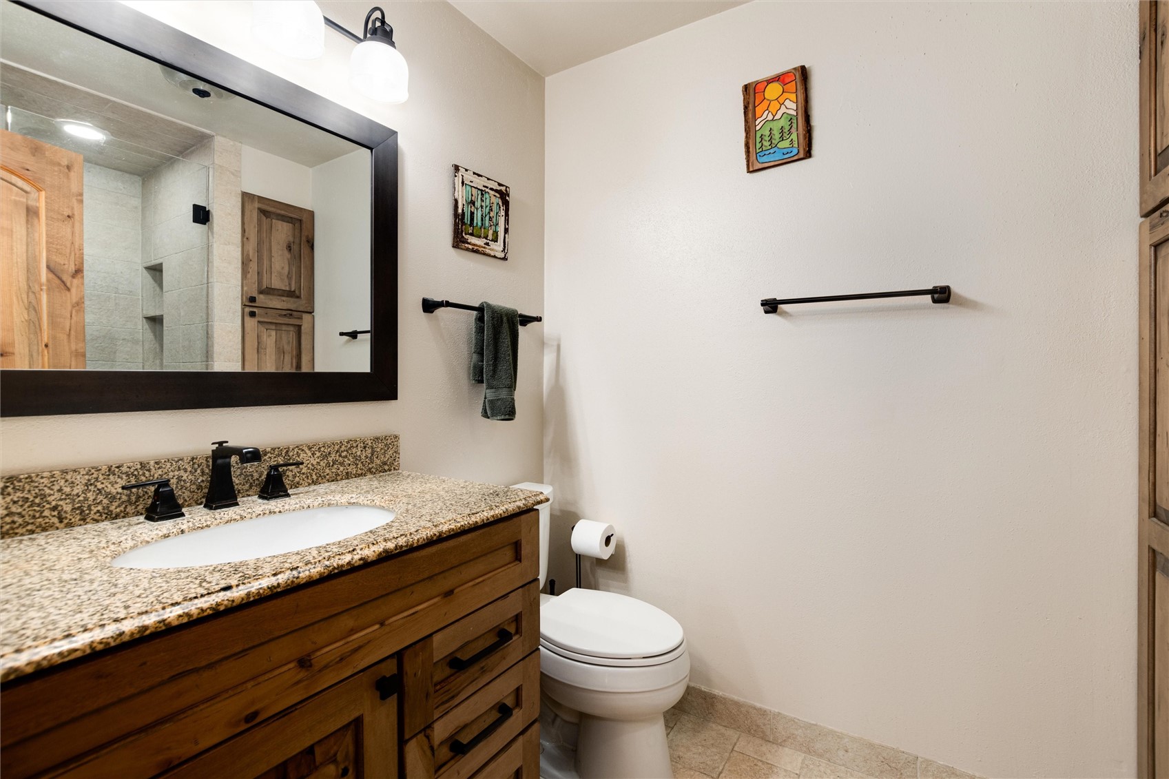 384 Blue Ridge Road Breckenridge, CO 80424 - Photo 18 of 39 a bathroom with a granite countertop toilet sink and mirror
