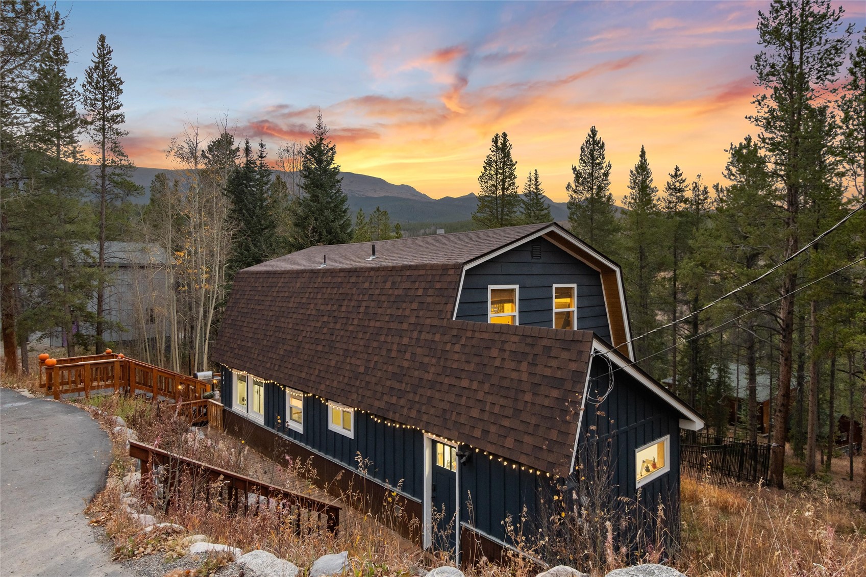 384 Blue Ridge Road Breckenridge, CO 80424 - Photo 27 of 39 a view of house with wooden deck and trees in the background