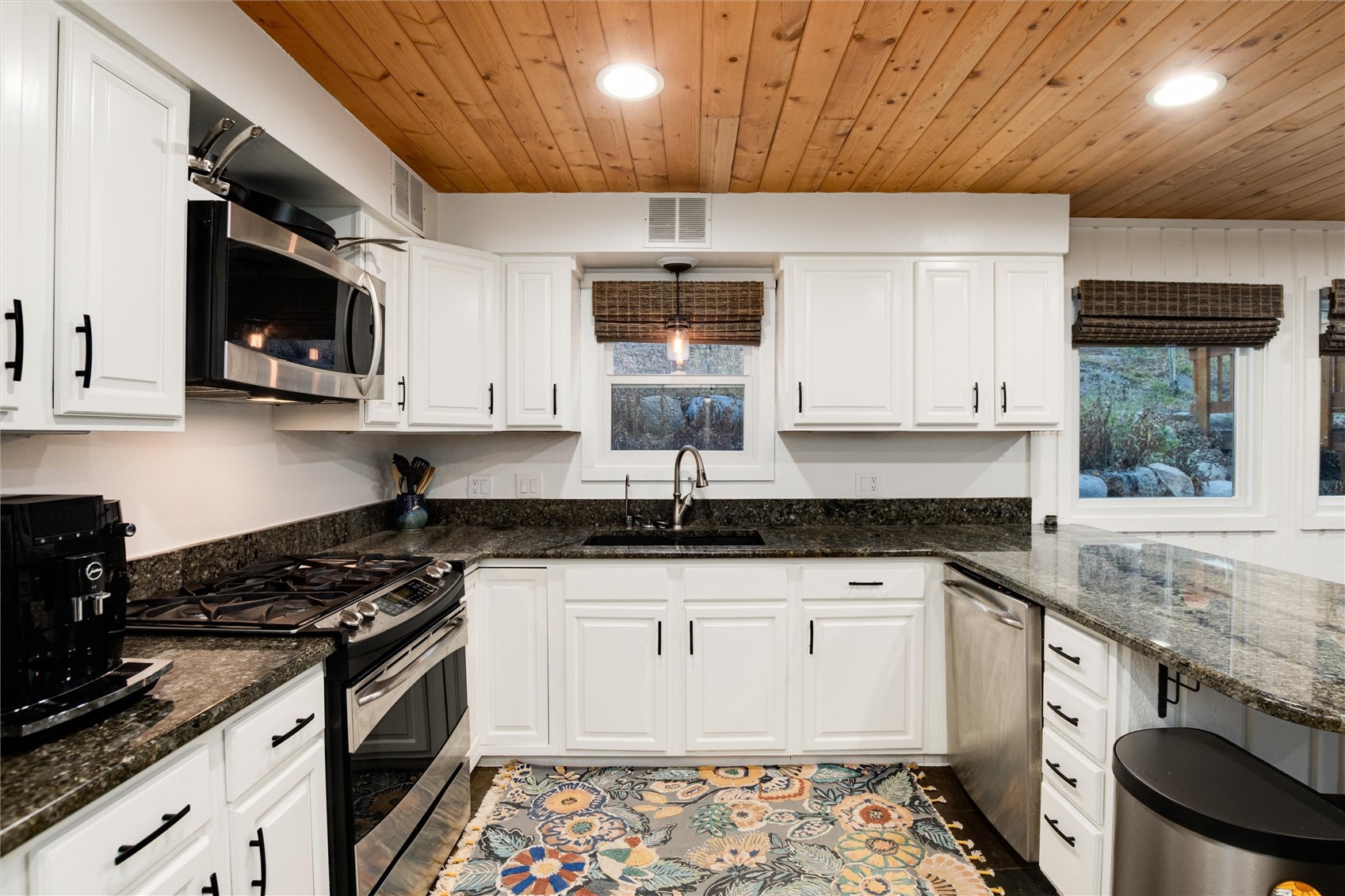 384 Blue Ridge Road Breckenridge, CO 80424 - Photo 6 of 39 a kitchen with stainless steel appliances granite countertop a sink stove and cabinets