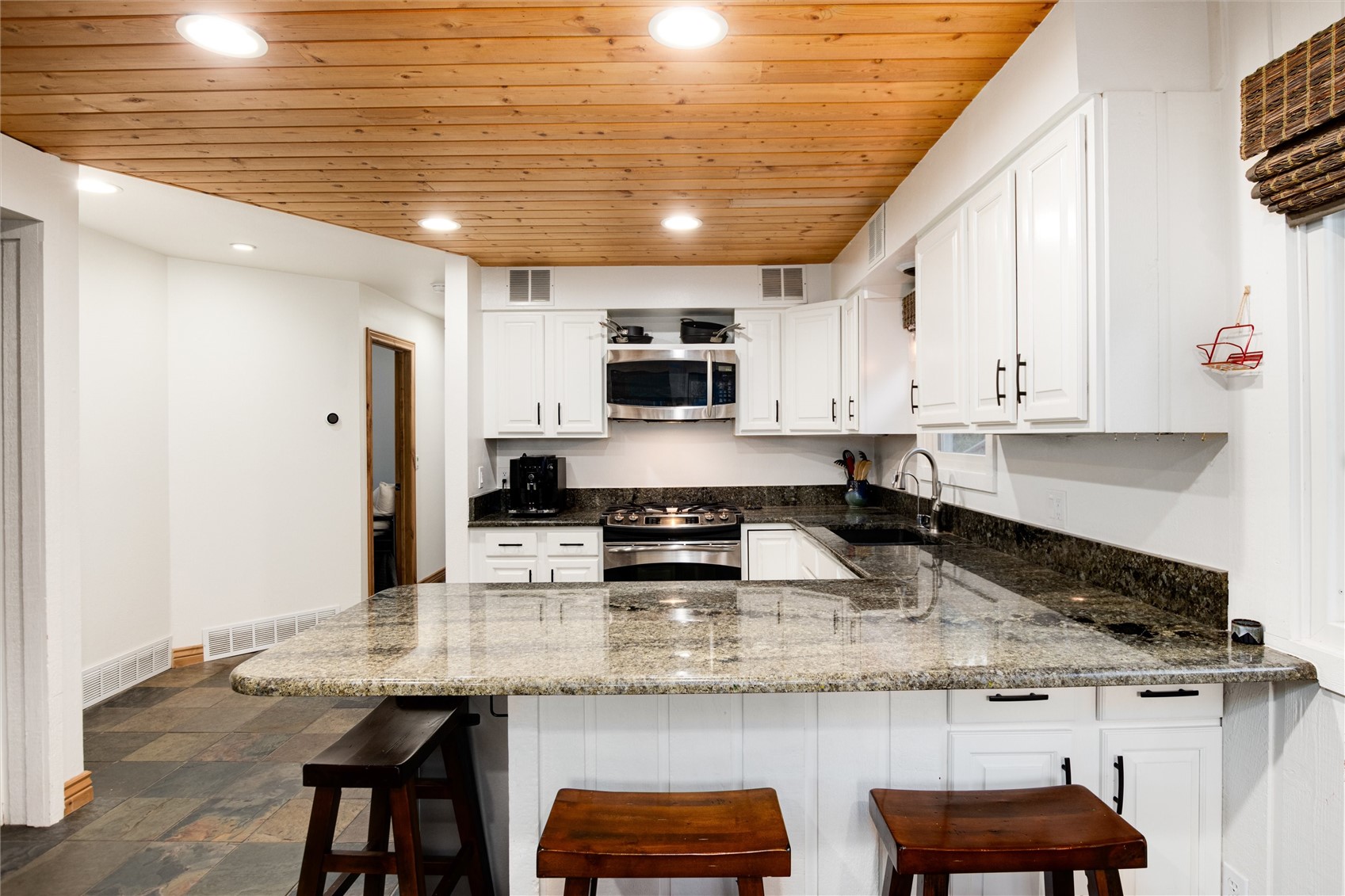 384 Blue Ridge Road Breckenridge, CO 80424 - Photo 7 of 39 a kitchen with stainless steel appliances granite countertop a sink and cabinets