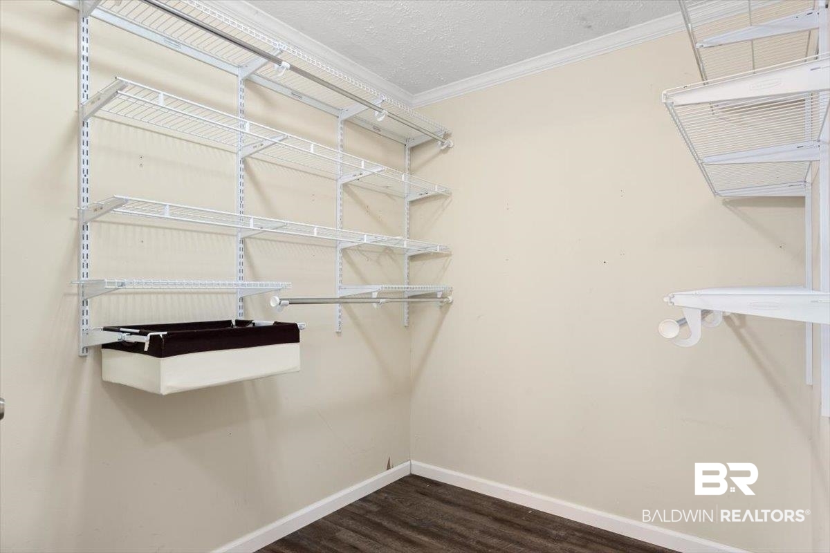 6971 March Road Theodore, AL 36582 - Photo 16 of 26 Spacious closet featuring dark wood finished floors