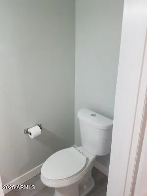 a white toilet sitting next to a shower