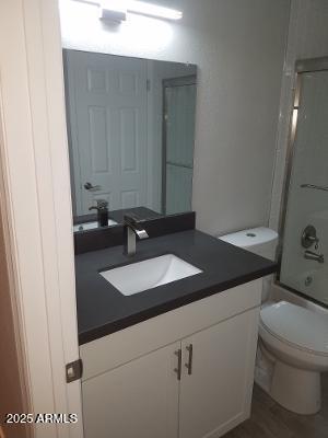 3719 East Inverness Avenue, Unit 91 Mesa, AZ 85206 - Photo 21 of 28 a bathroom with a granite countertop sink and a mirror