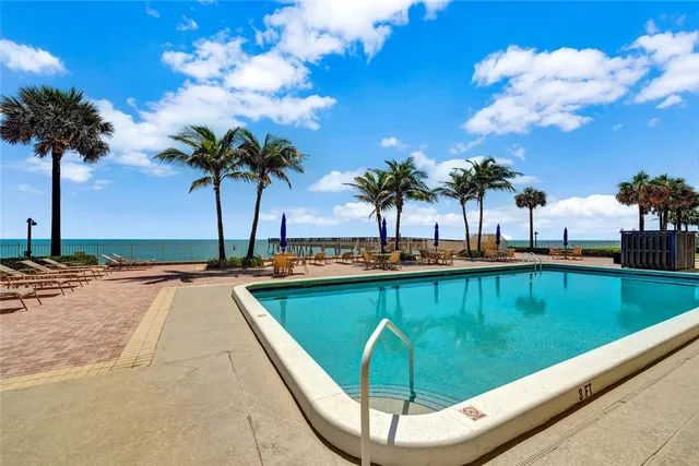 a living room with furniture and a book shelf