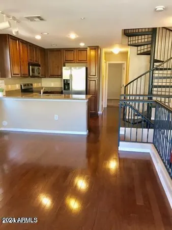 a view of kitchen with stainless steel appliances refrigerator stove microwave and cabinets