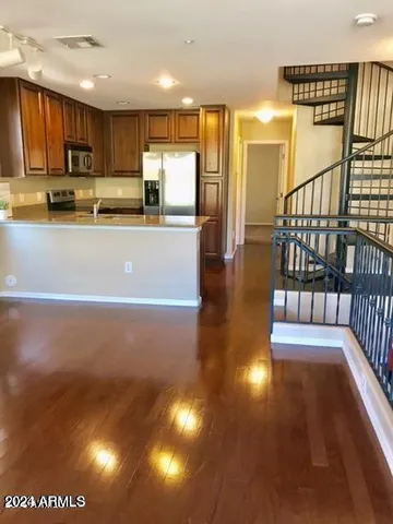 a view of kitchen with stainless steel appliances refrigerator stove microwave and cabinets