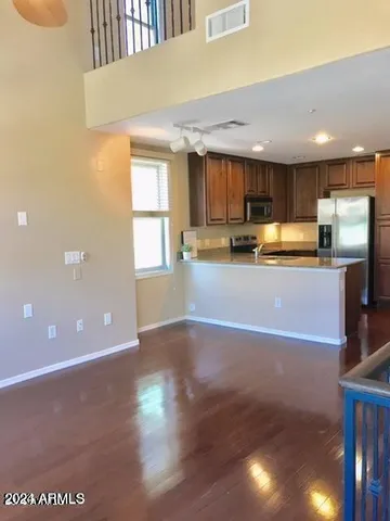 a kitchen with stainless steel appliances granite countertop a sink a stove top oven a counter space and cabinets