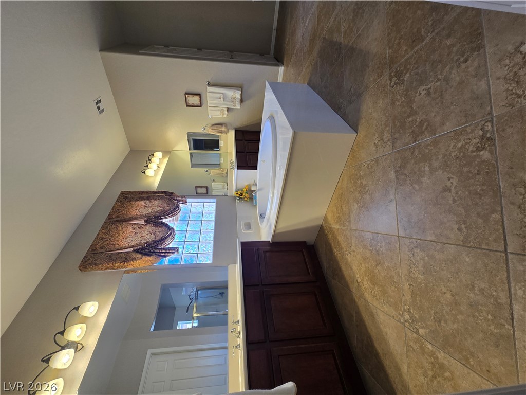 2567 Dirleton Place Henderson, NV 89044 - Photo 32 of 67 Relax and unwind in this primary bath featuring a dual vanity, generous soaking tub, and natural light.