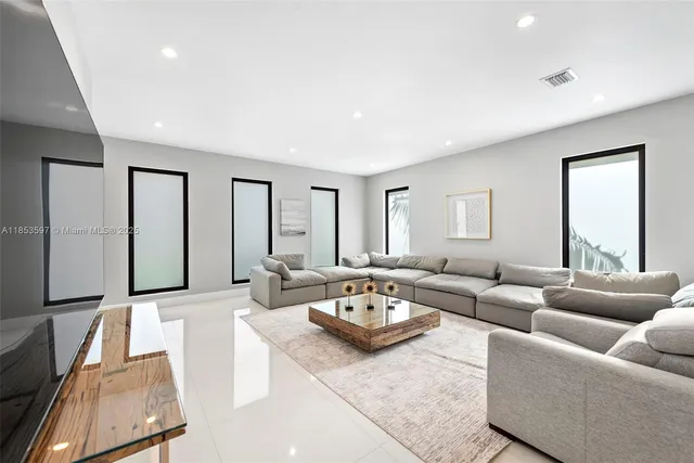 a bedroom with a large window and a flat screen tv