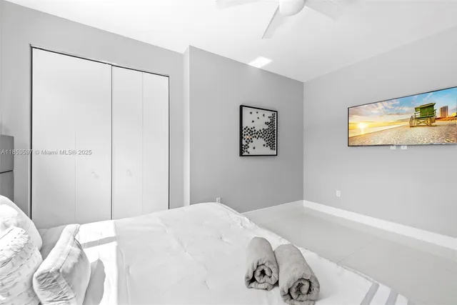 a bedroom with a bed and a painting on the wall