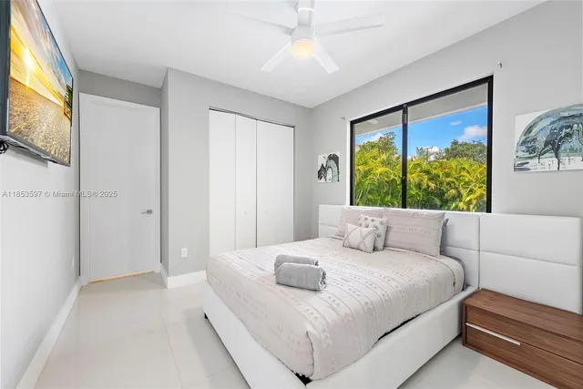 a bedroom with a bed and a large window