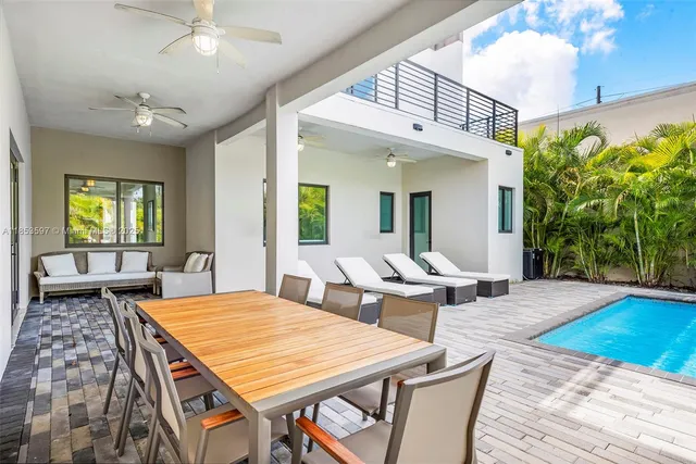 a living room with furniture a rug and a window