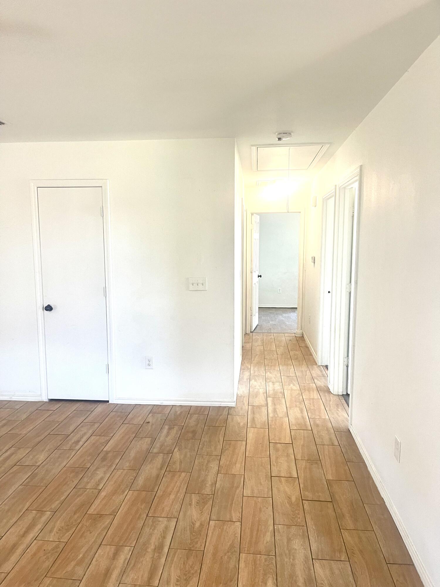 602 43rd Street Lubbock, TX 79404 - Photo 4 of 8 a view of a room with wooden floor and a hallway