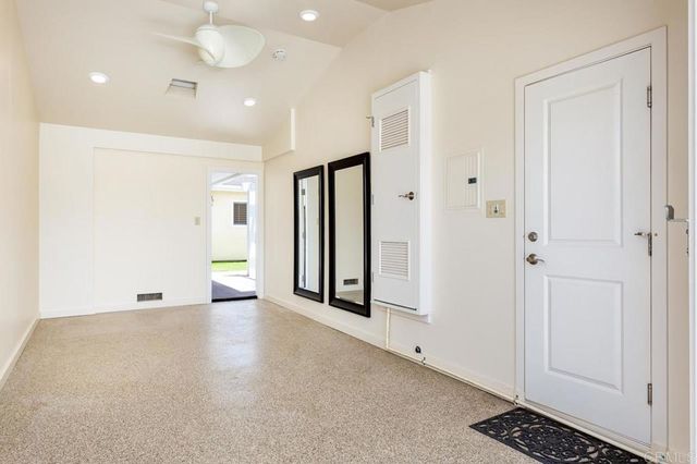 an empty room with windows and closet