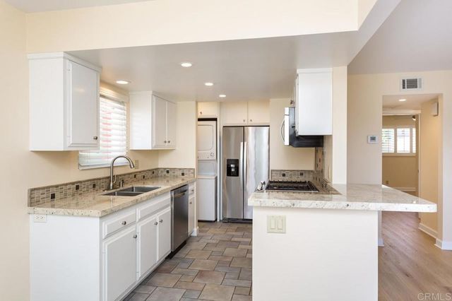 a kitchen with a sink stove and refrigerator