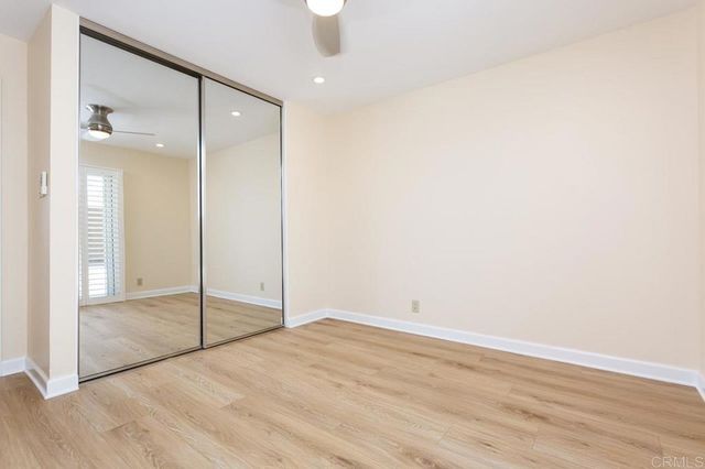an empty room with wooden floor and door