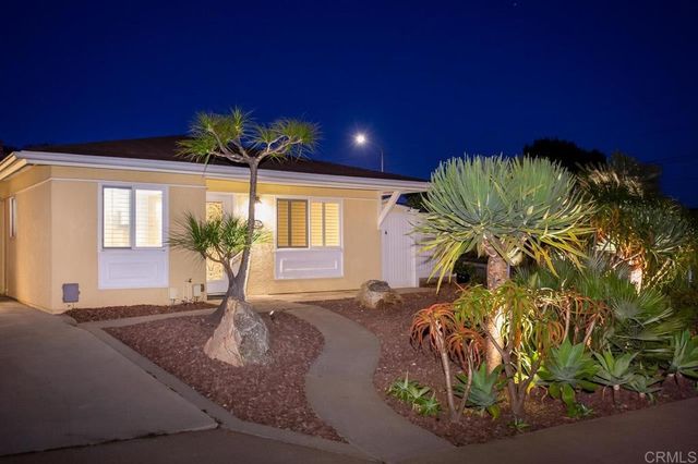 a vase of flowers sitting on a table in front of a window