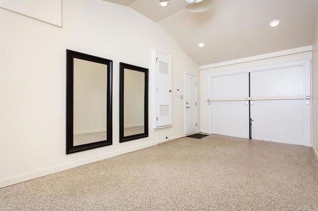 an empty room with a empty space and mirror