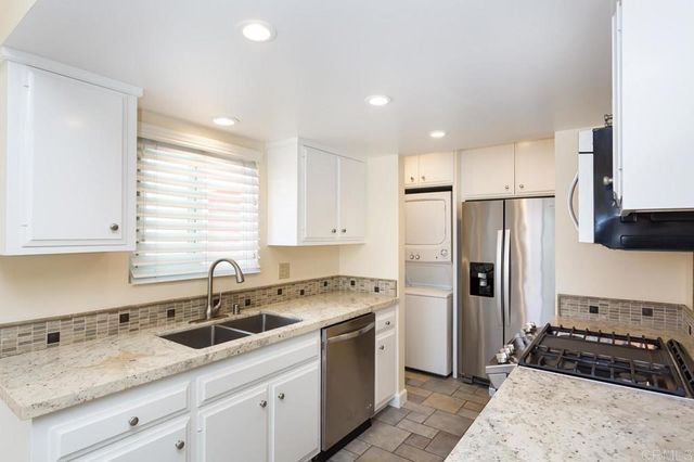 a kitchen with a sink stove and refrigerator