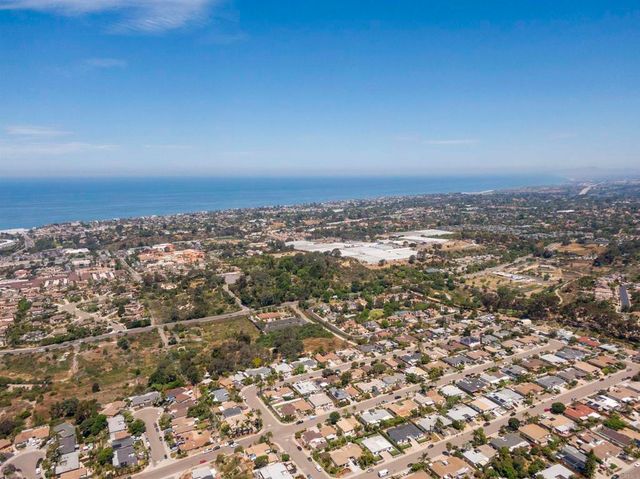 an aerial view of residential building and trees around