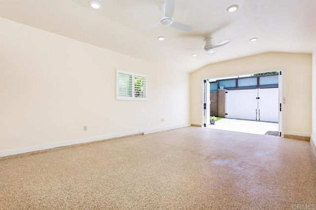 an empty room with a empty space and windows