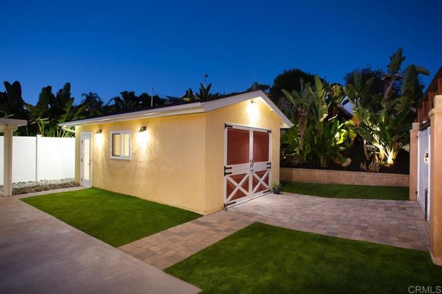 a view of a backyard with a garden and trees