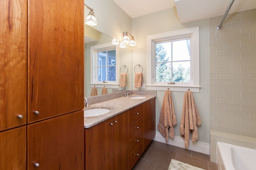 86 Pickwick Road Newton, MA 02465 - Photo 11 of 16 a bathroom with a double vanity sink and a mirror