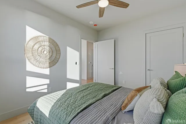 a bedroom with a large bed and a chandelier