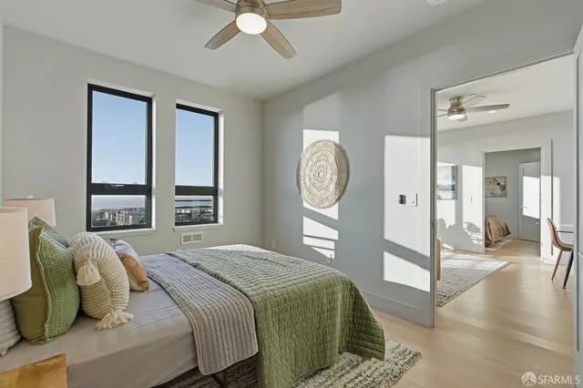 a bedroom with a large bed and a chandelier