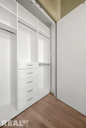 a bedroom with a bed and a mirror
