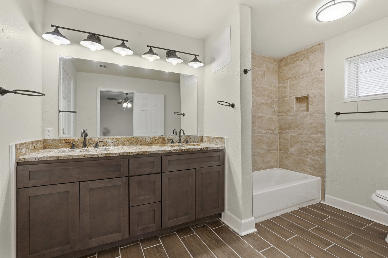 2518 Henderson Lane Deer Park, TX 77536 - Photo 19 of 28 a bathroom with a granite countertop sink mirror and shower