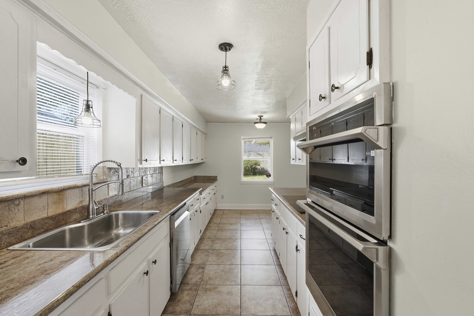 2518 Henderson Lane Deer Park, TX 77536 - Photo 8 of 28 a kitchen with stainless steel appliances a sink stove and cabinets