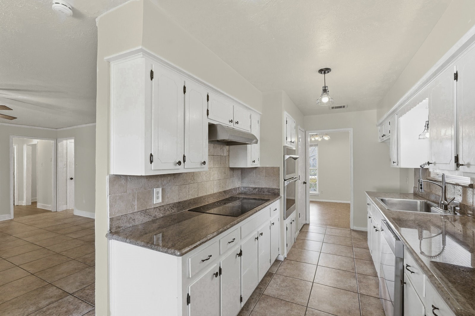 2518 Henderson Lane Deer Park, TX 77536 - Photo 10 of 28 a kitchen with stainless steel appliances granite countertop a sink and cabinets