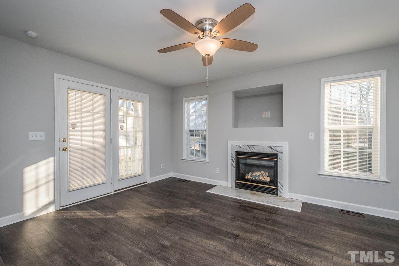 4312 Windlass Court Raleigh, NC 27616 - Photo 11 of 22 wooden floor fireplace and windows in an empty room