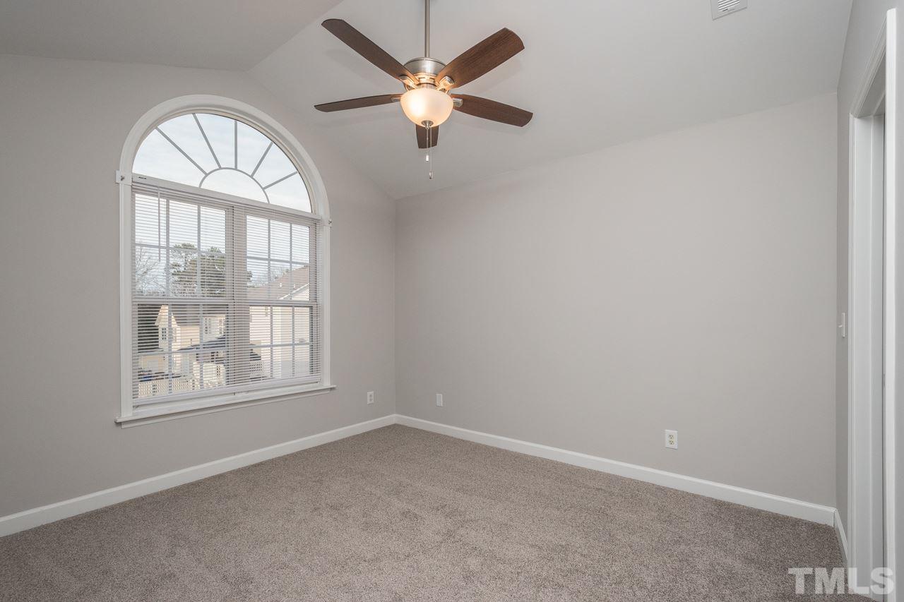4312 Windlass Court Raleigh, NC 27616 - Photo 12 of 22 an empty room with a window and a ceiling fan