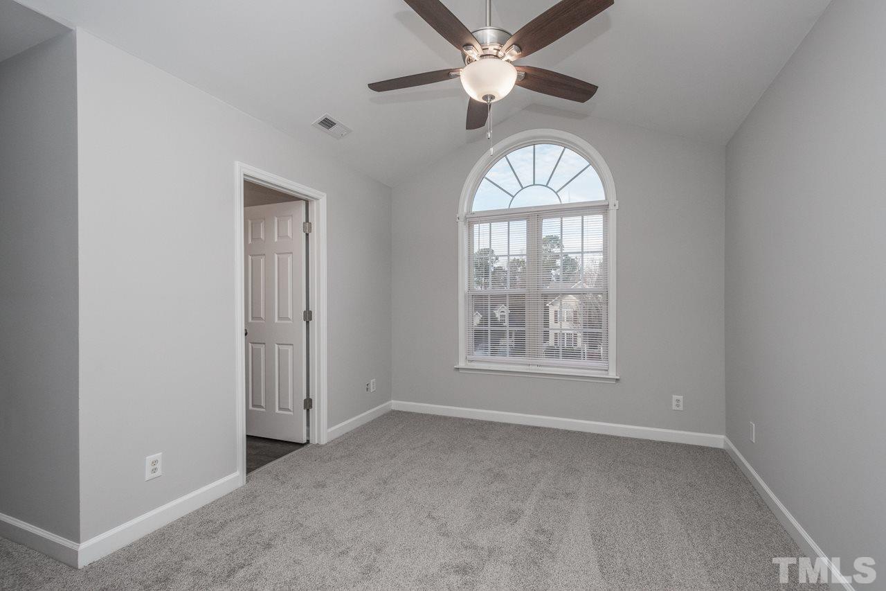 4312 Windlass Court Raleigh, NC 27616 - Photo 13 of 22 an empty room with a window and a ceiling fan