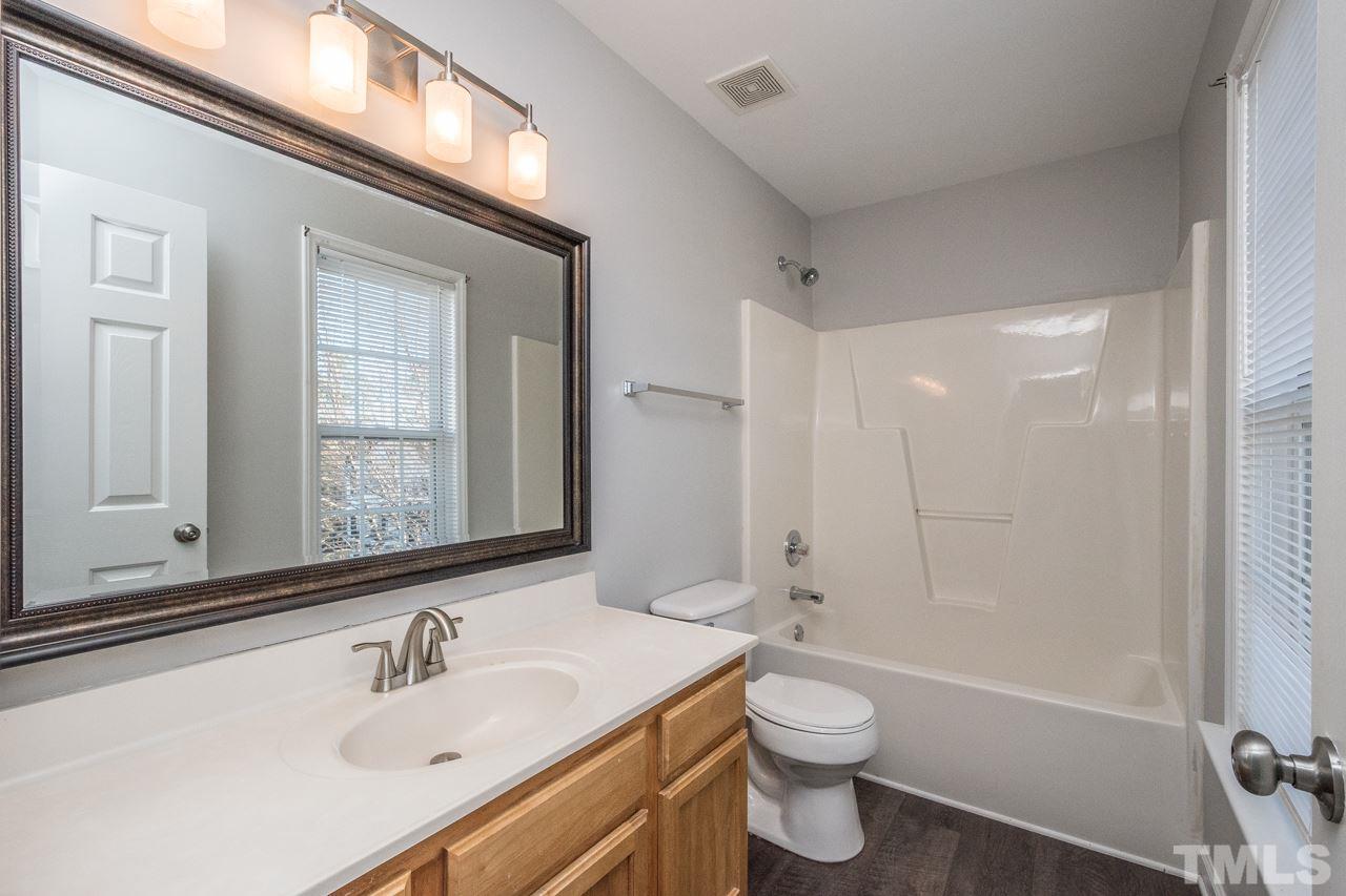 4312 Windlass Court Raleigh, NC 27616 - Photo 14 of 22 a bathroom with a sink a toilet and shower