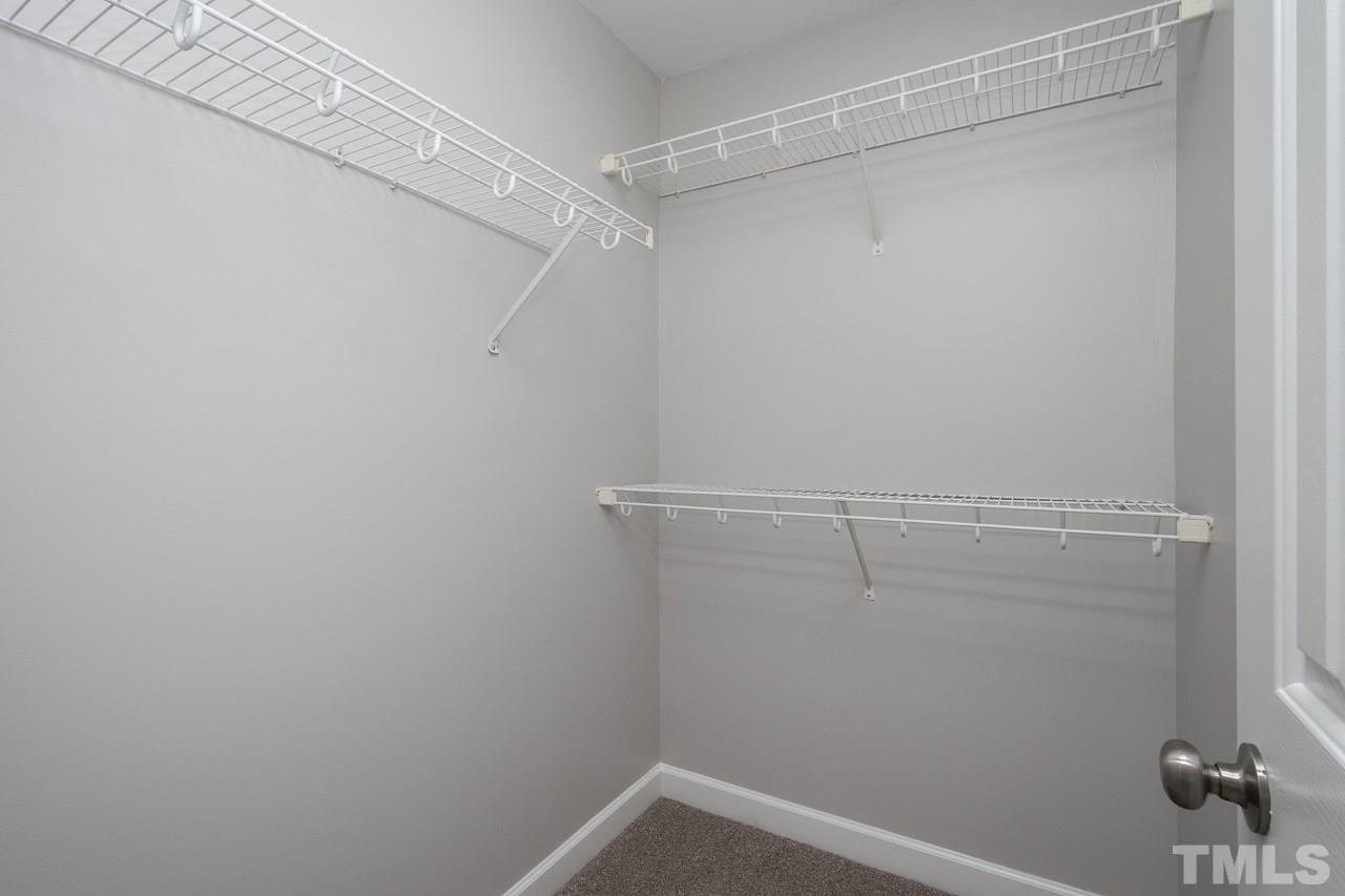 4312 Windlass Court Raleigh, NC 27616 - Photo 15 of 22 a view of a room with racks on the wall