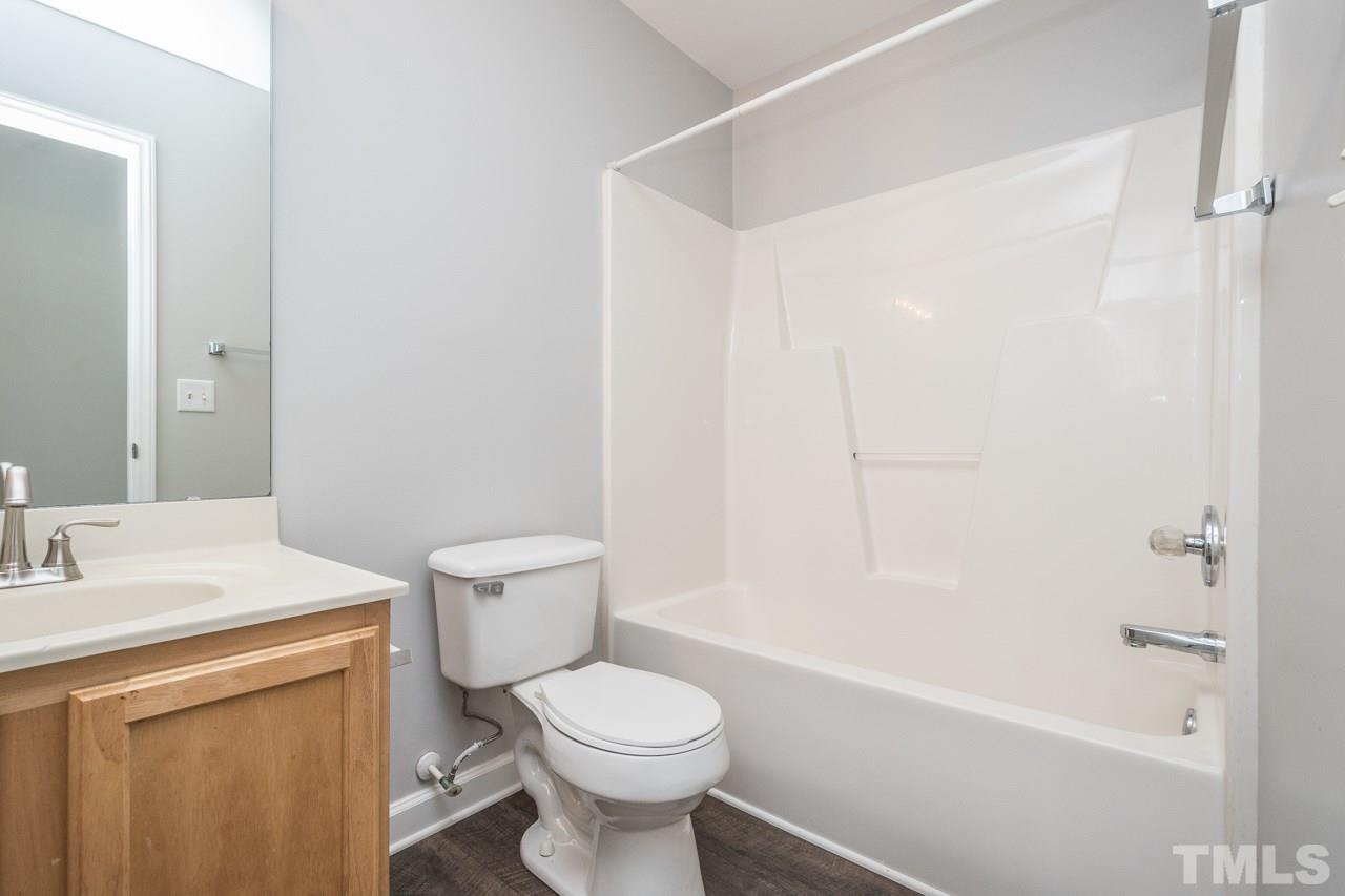 4312 Windlass Court Raleigh, NC 27616 - Photo 18 of 22 a bathroom with a sink a toilet and shower