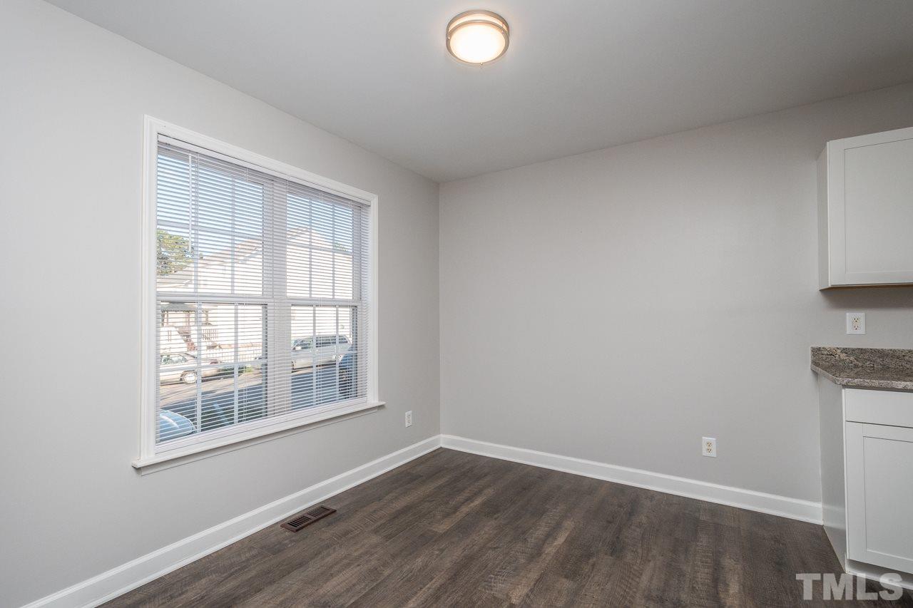 4312 Windlass Court Raleigh, NC 27616 - Photo 8 of 22 an empty room with wooden floor and windows