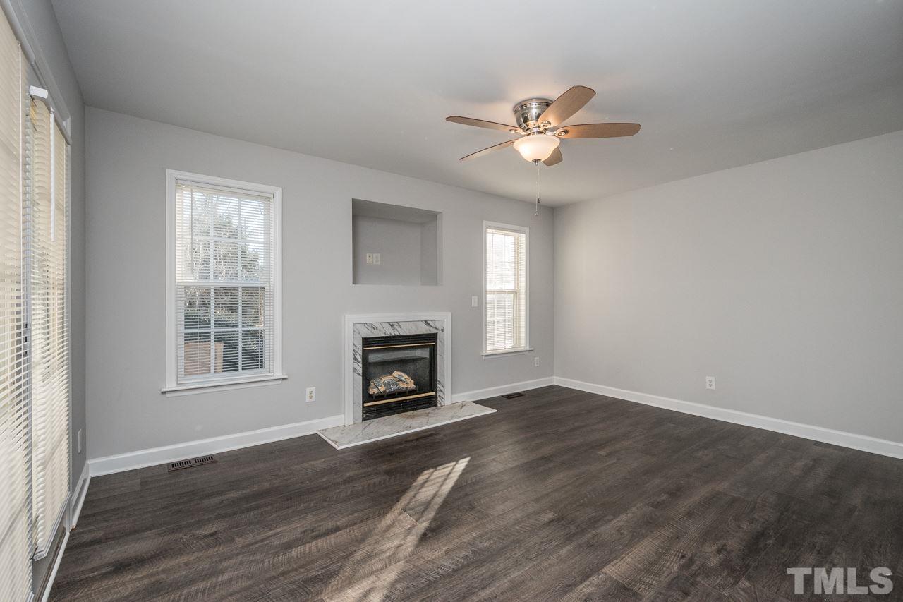 4312 Windlass Court Raleigh, NC 27616 - Photo 9 of 22 a view of main area with chandelier fan and fireplace
