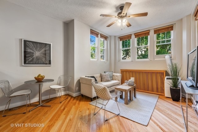 647 West Sheridan Road, Unit 1E Chicago, IL 60613 - Photo 9 of 17 a living room with furniture and a fireplace