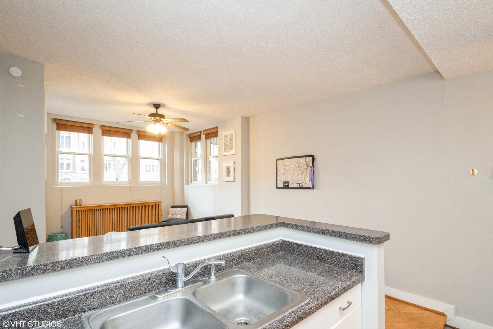 647 West Sheridan Road, Unit 1E Chicago, IL 60613 - Photo 10 of 17 a bathroom with a granite countertop sink and a large mirror